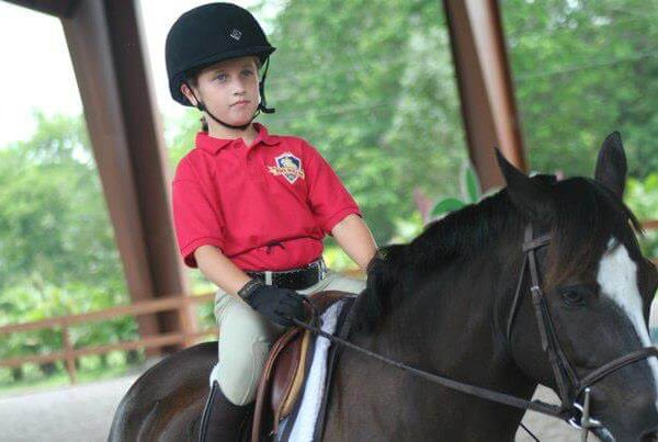 Kid riding horse at the Pine Hollow Camp